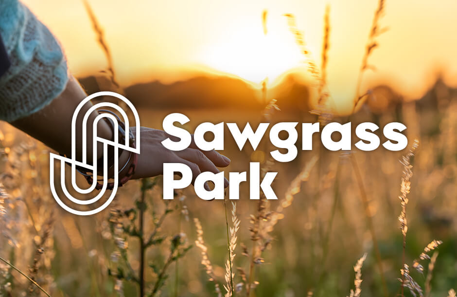 Sawgrass Park logo over community landscape