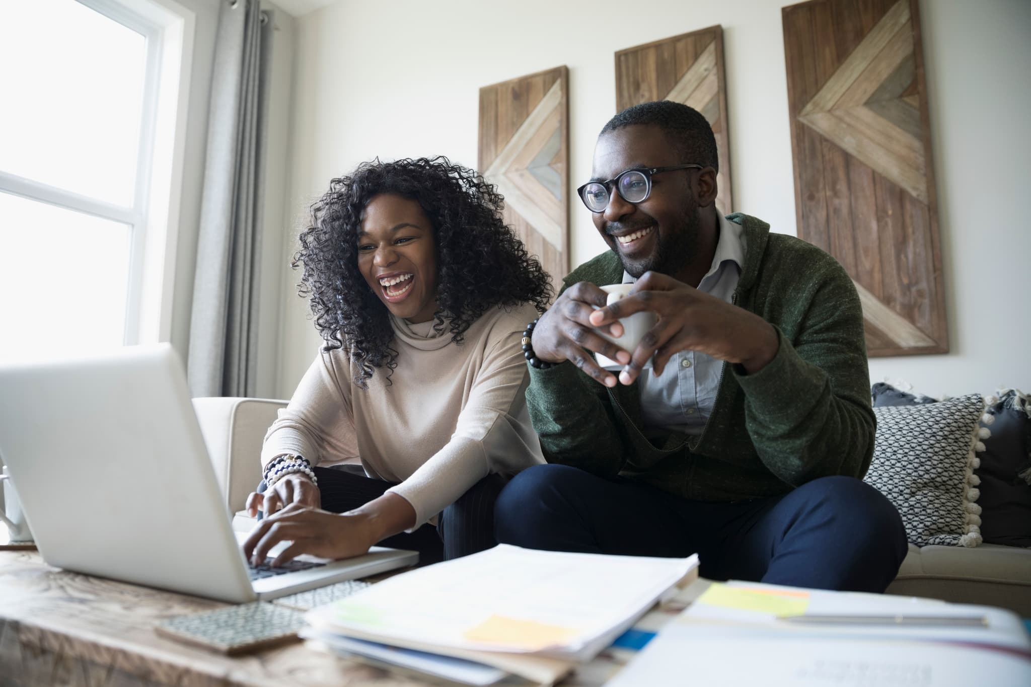 couple smiling at their laptop