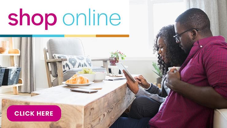 Text reads: Shop Online. Image: Man and woman looking at an iPad within their home.